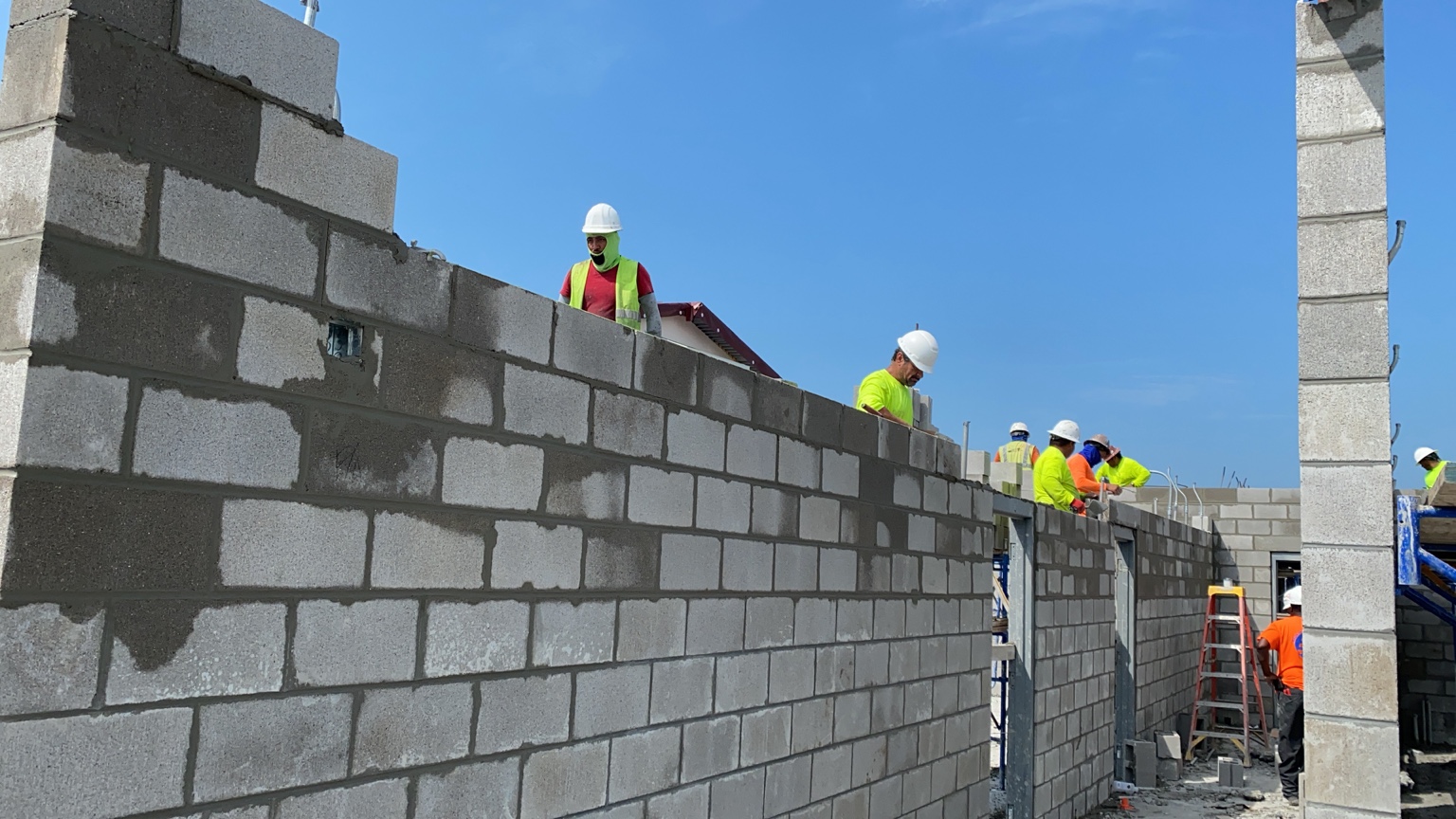 Masons constructing commercial CMU walls