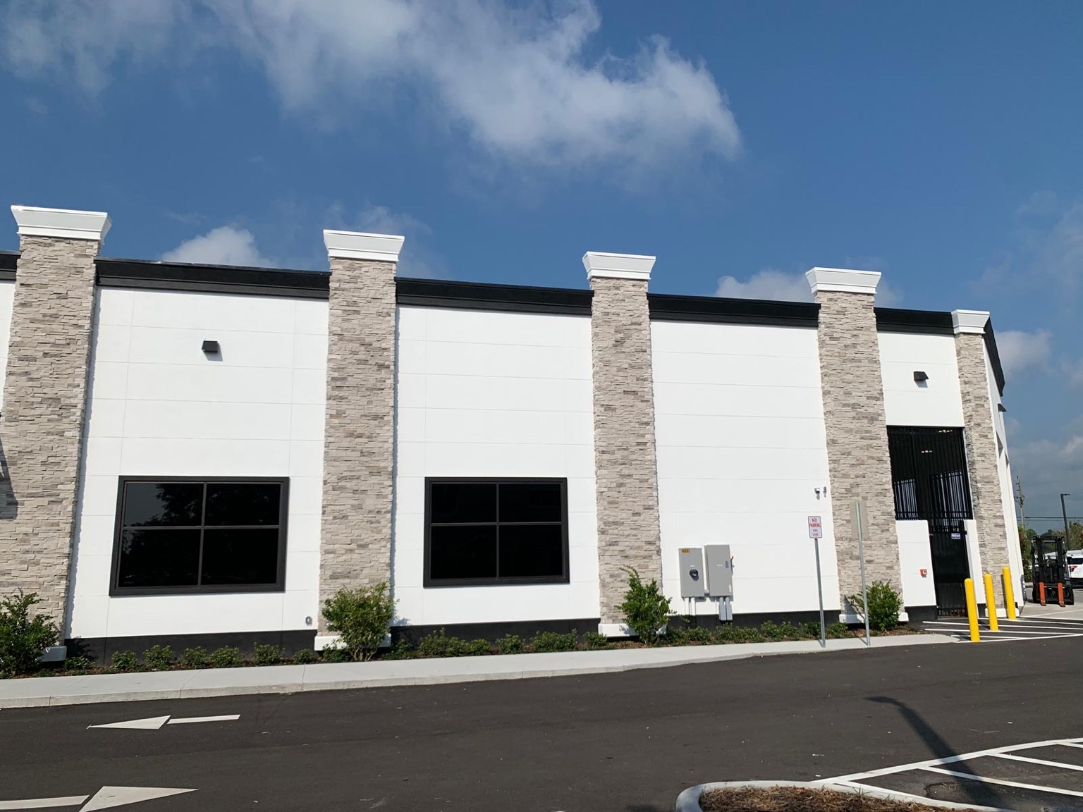 Beige stone veneer pilasters on a finished commercial exterior